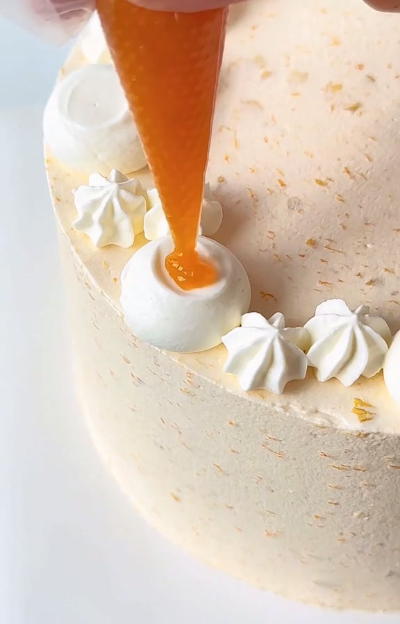 decorate with additional piped cream, fresh apricot slices