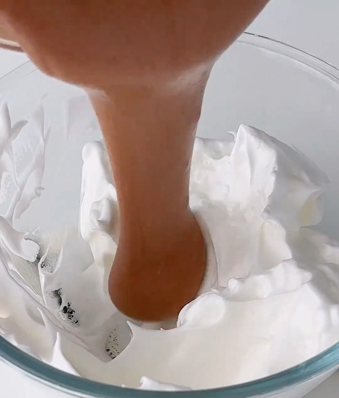 pour this mixture back into the bowl with the remaining meringue