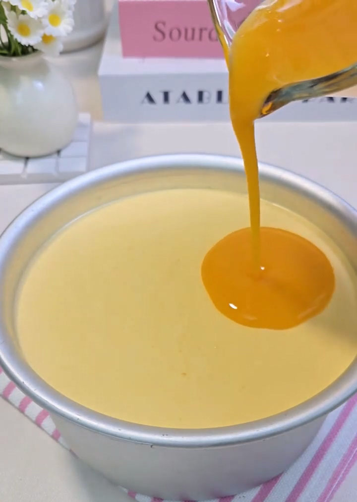 slowly pour the cooled mango glaze over the top of the semi set mousse