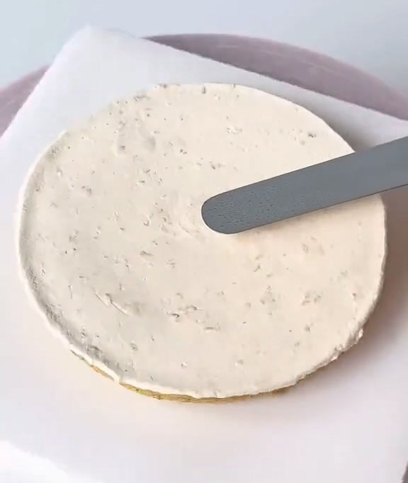 using a spatula to smooth it flat