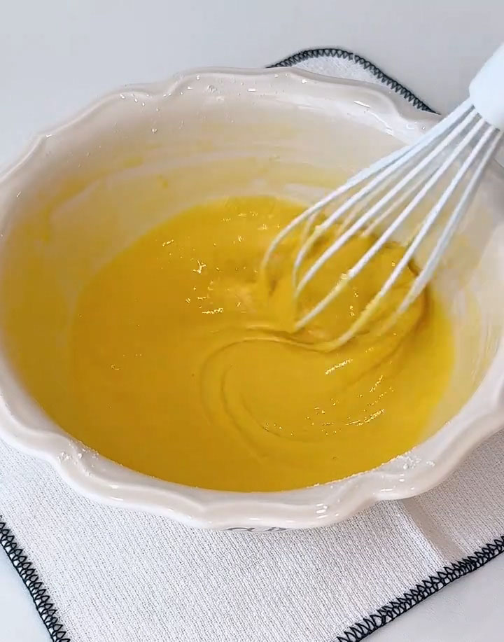 Add 55 g low protein flour and stir with a spatula or whisk until no dry flour remains and the mixture looks like a thick paste