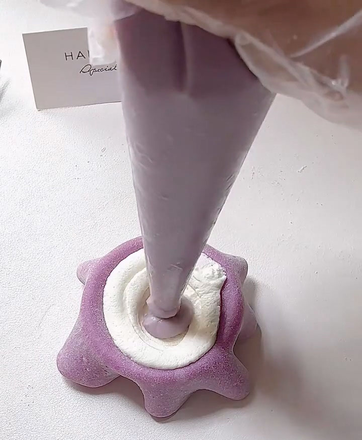 Add a spoonful of the taro filling on top of the cream.