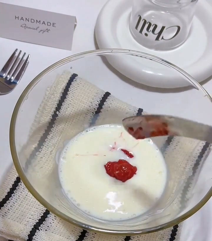 Add the 50 g of strawberry jam to the bowl