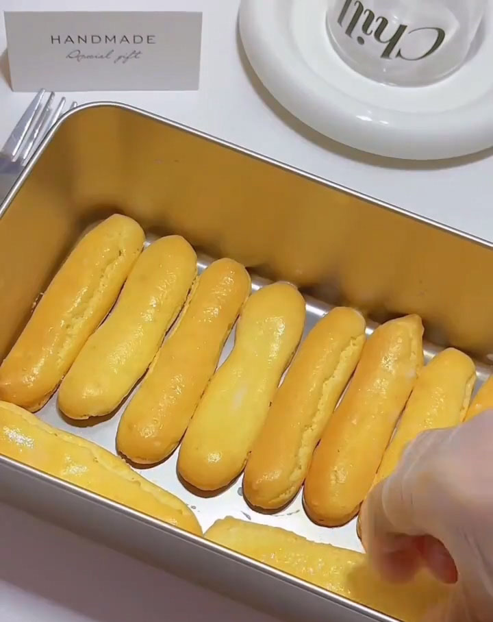 Arrange the dipped ladyfingers in a single layer