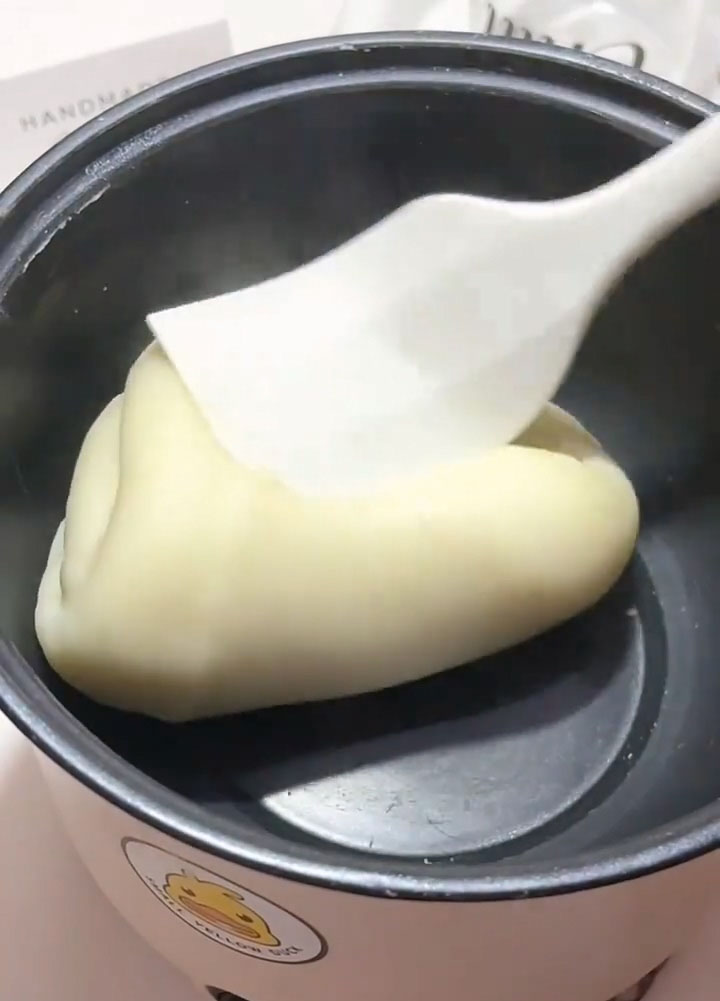 Continue stirring and folding until the dough forms a complete, cohesive ball that pulls away cleanly from the sides and bottom of the pan