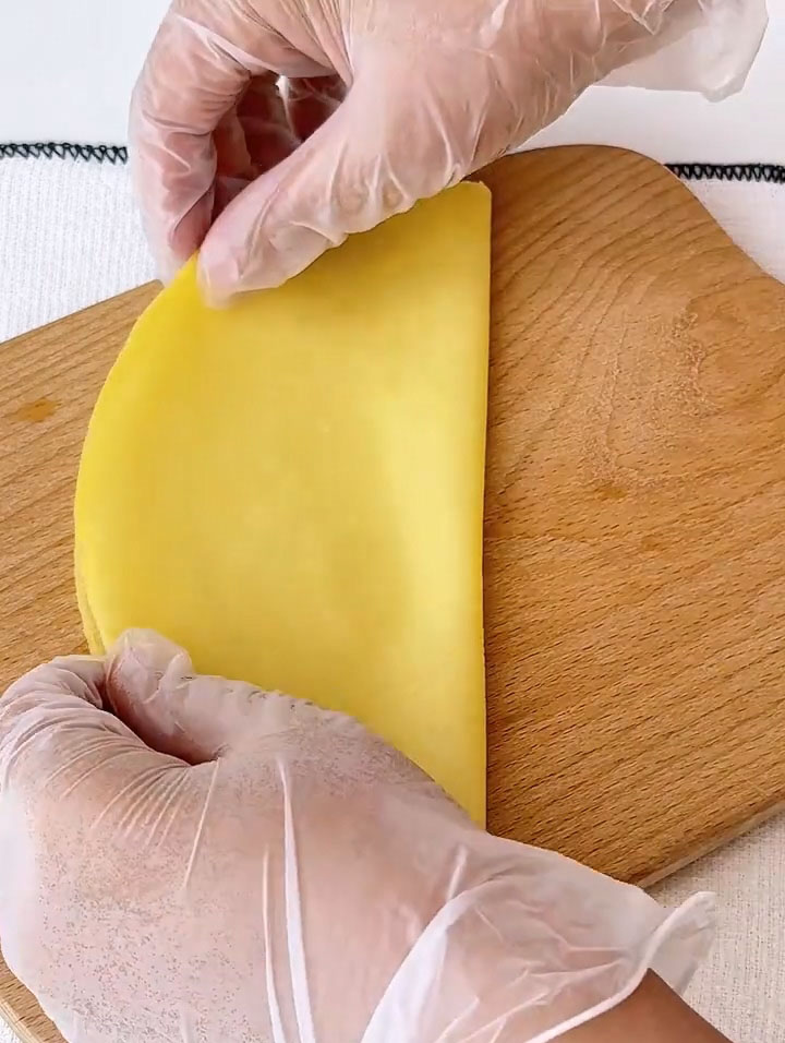 Fold it gently in half to create a half moon shape.