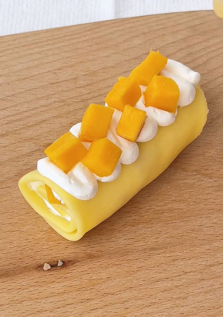 Garnish with fresh mango chunks and a light sprinkle of shredded coconut