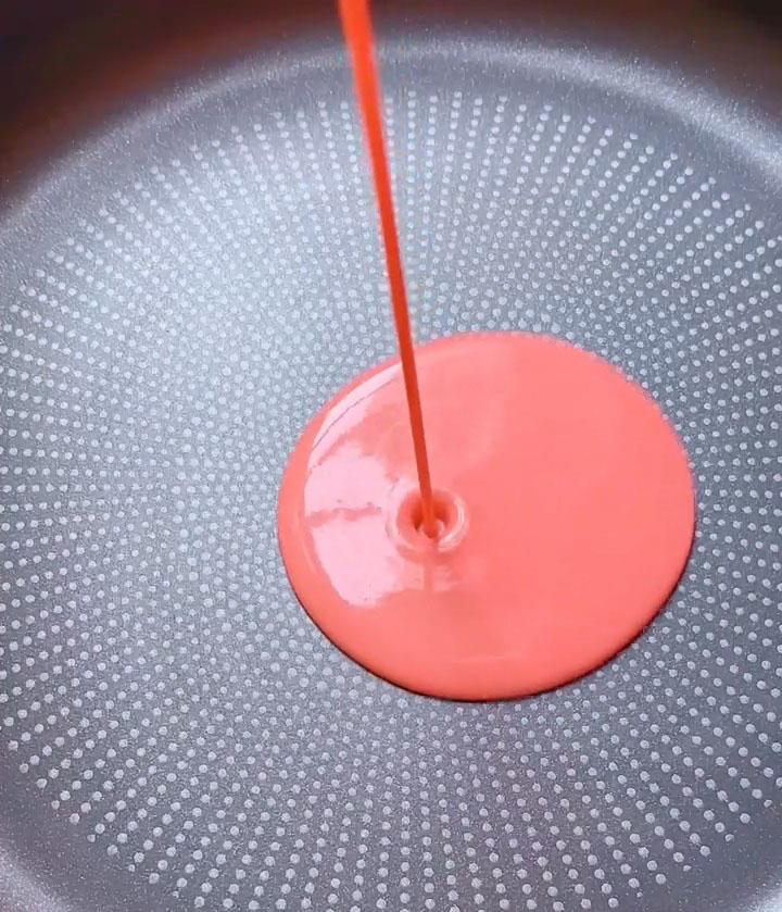 Ladle a small amount of batter into the center of the pan