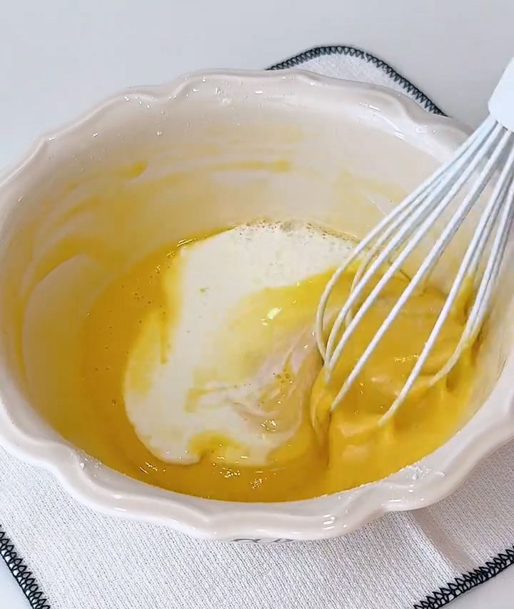 Now add the room temperature milk in two separate batches