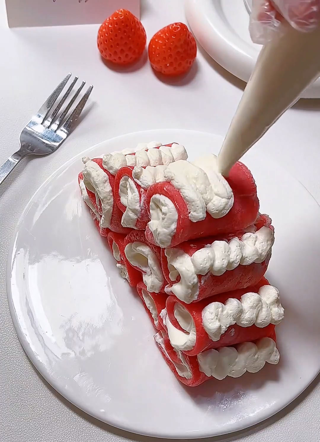 Pipe a small dollop of cream on top of the mini towel rolls