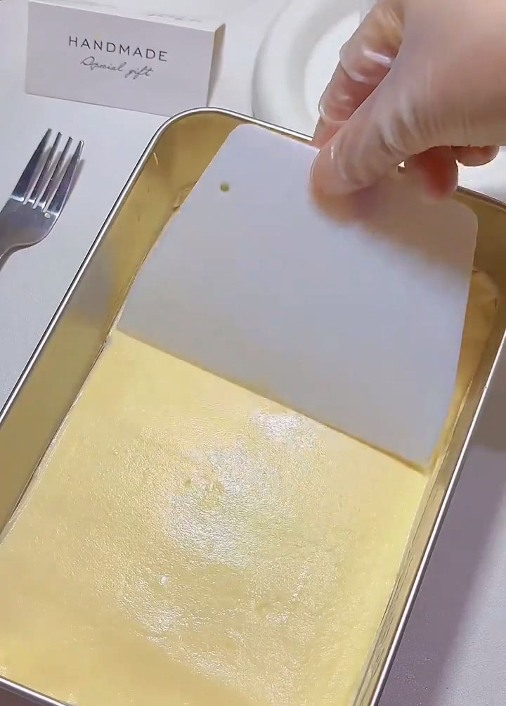 Pipe or spoon half of the cheese and cream mixture over the top and spread it evenly with a spatula