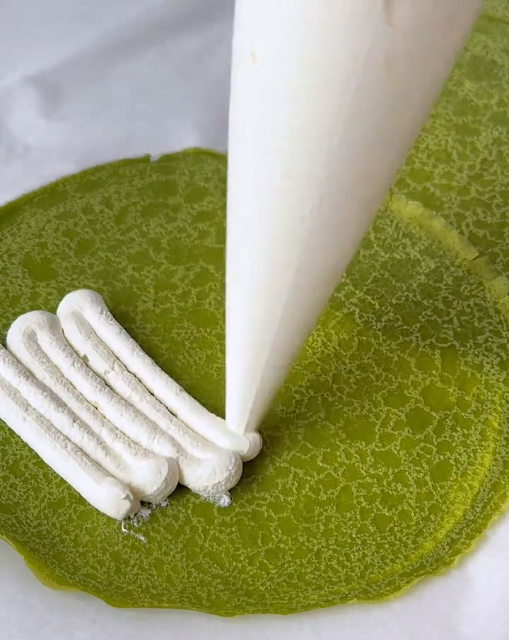 Pipe or spread the whipped cream evenly over the crepes