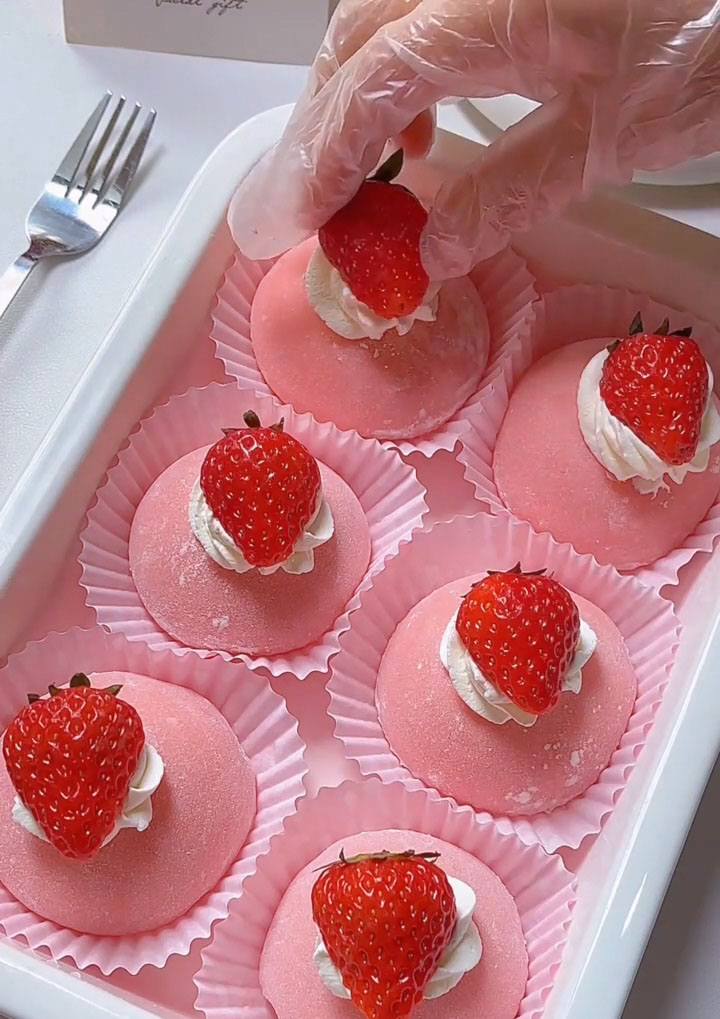 Place one fresh strawberry on top of the whipped cream swirl as the final garnish