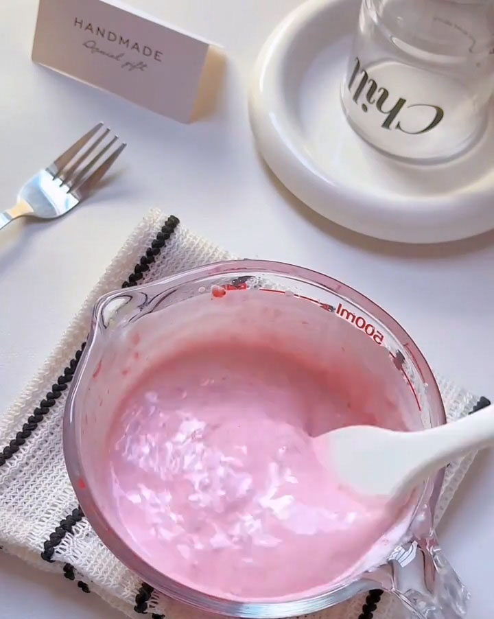 Pour in the whole milk and fold again until everything comes together into a smooth, cohesive strawberry cream mixture