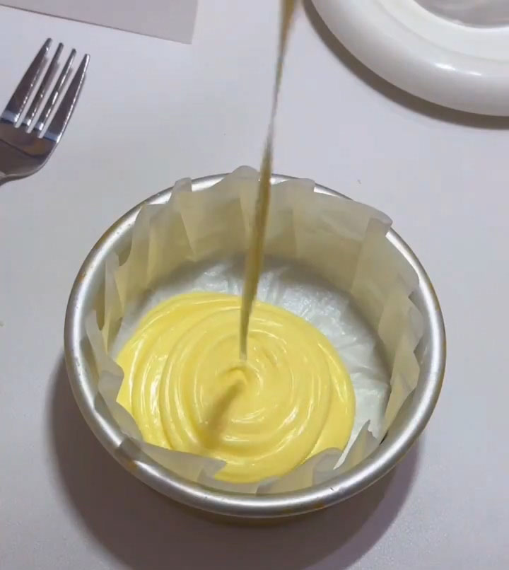 Pour the strained Basque batter into the prepared mold