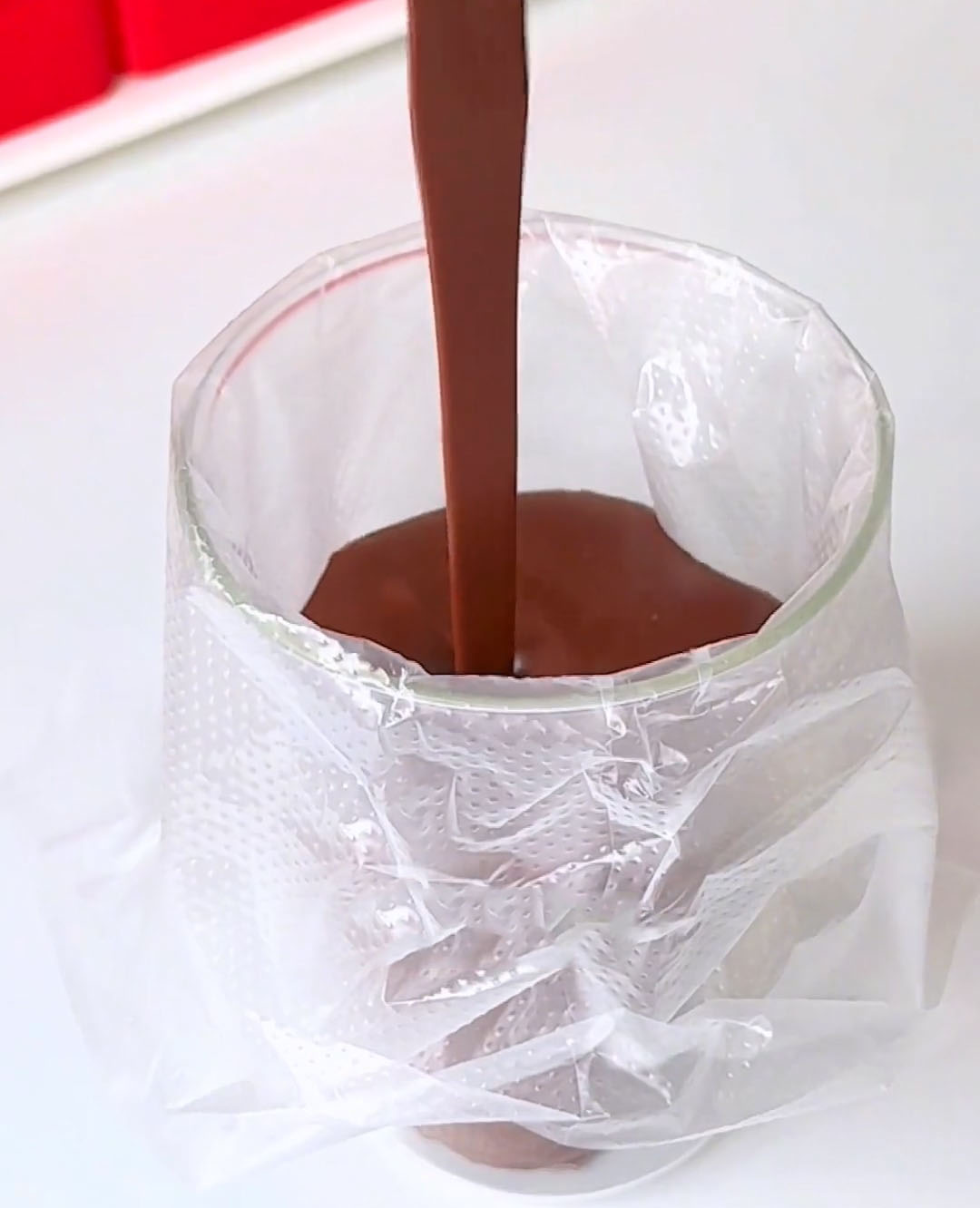 Pour the warm chocolate mixture into a piping bag