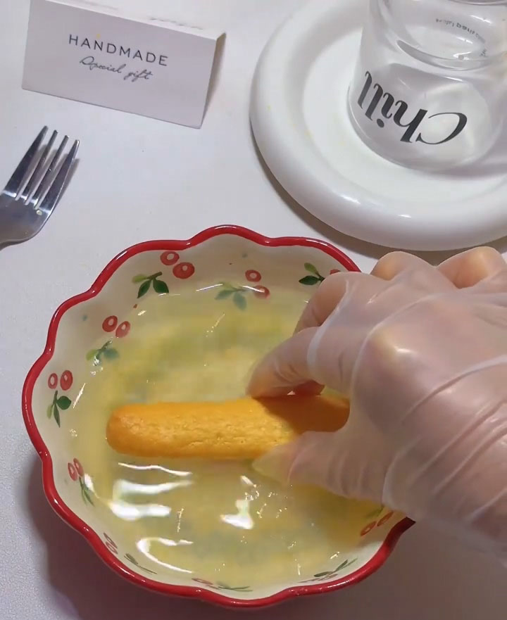 Quickly dip each ladyfinger into the syrup