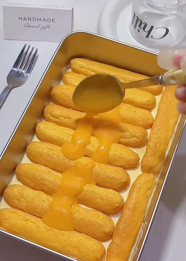 Repeat with another layer of syrup dipped ladyfingers, another brush of lemon curd