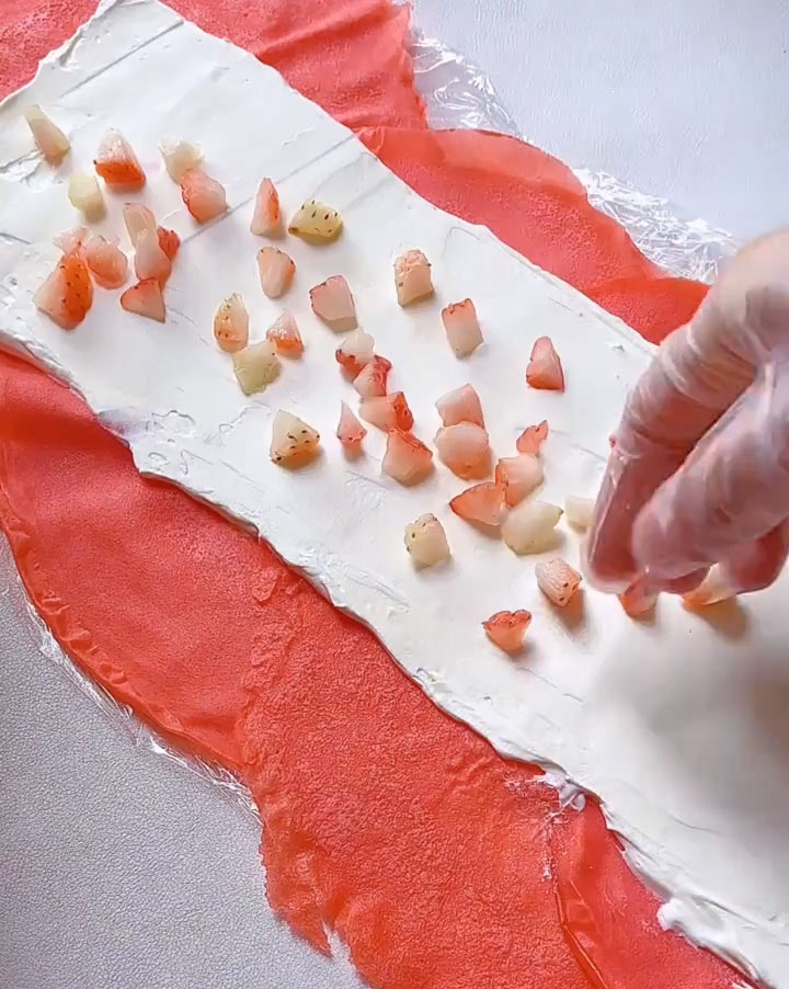 Sprinkle diced fresh strawberries evenly over the cream.