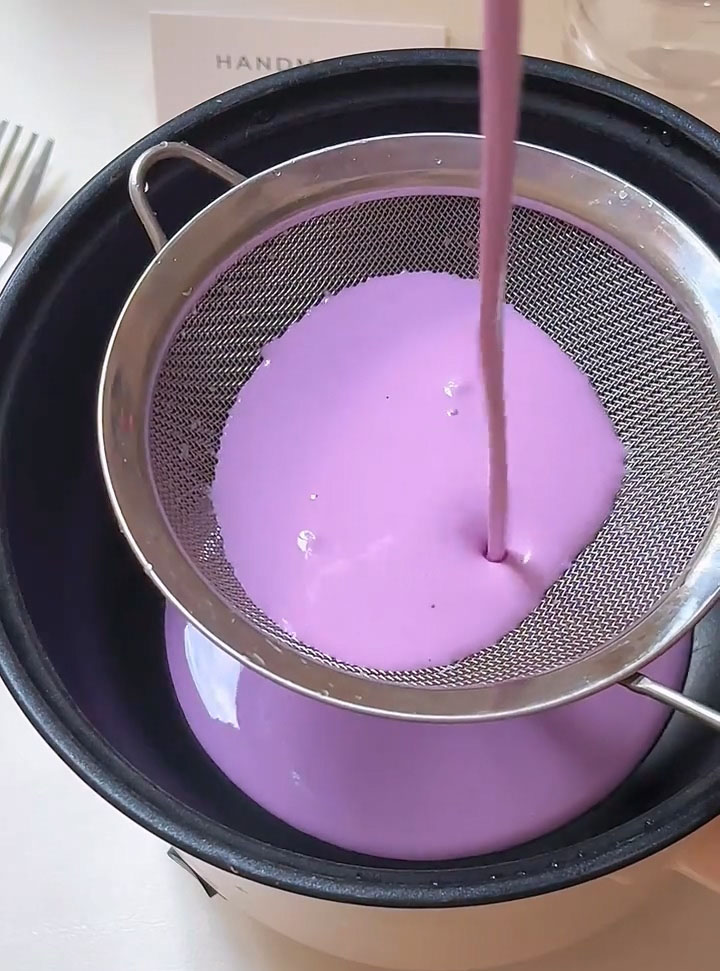 Strain the batter through a fine mesh sieve directly into a non stick pan.