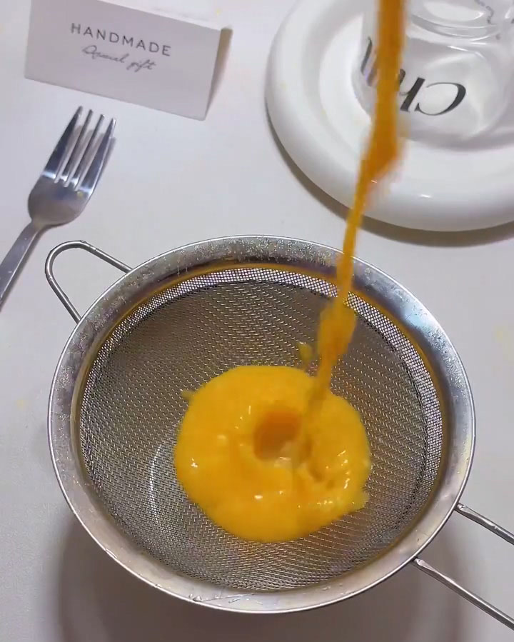 Strain the curd through a fine mesh sieve into a clean bowl
