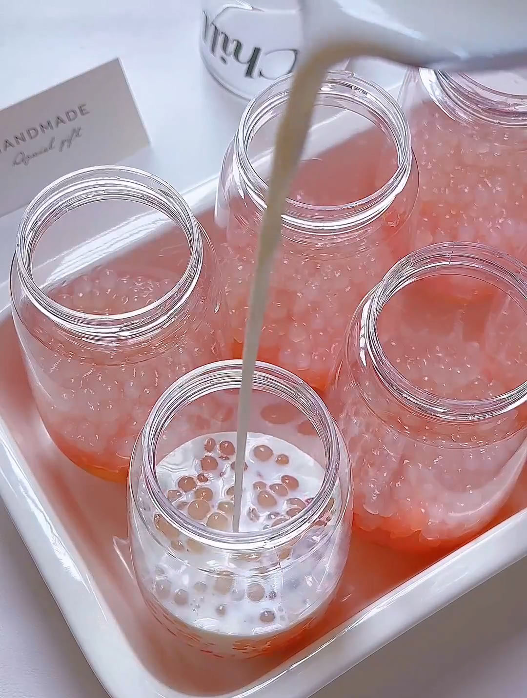 Then pour a small splash of milk into each glass