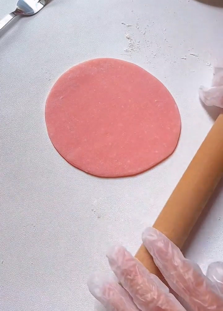 Use a rolling pin to flatten it into a thin, circular disc