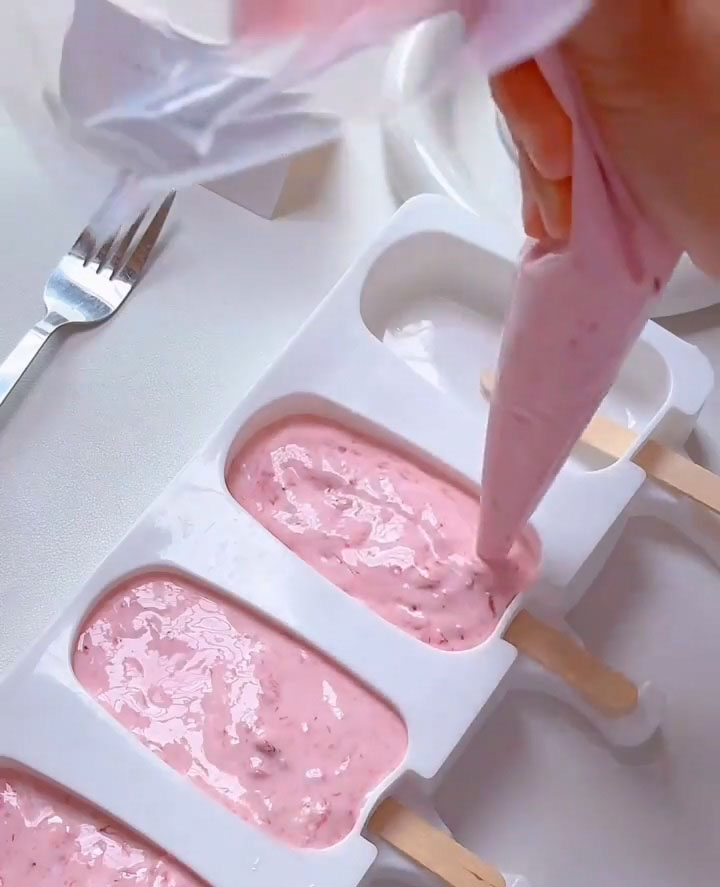 pipe the strawberry cream into your popsicle molds
