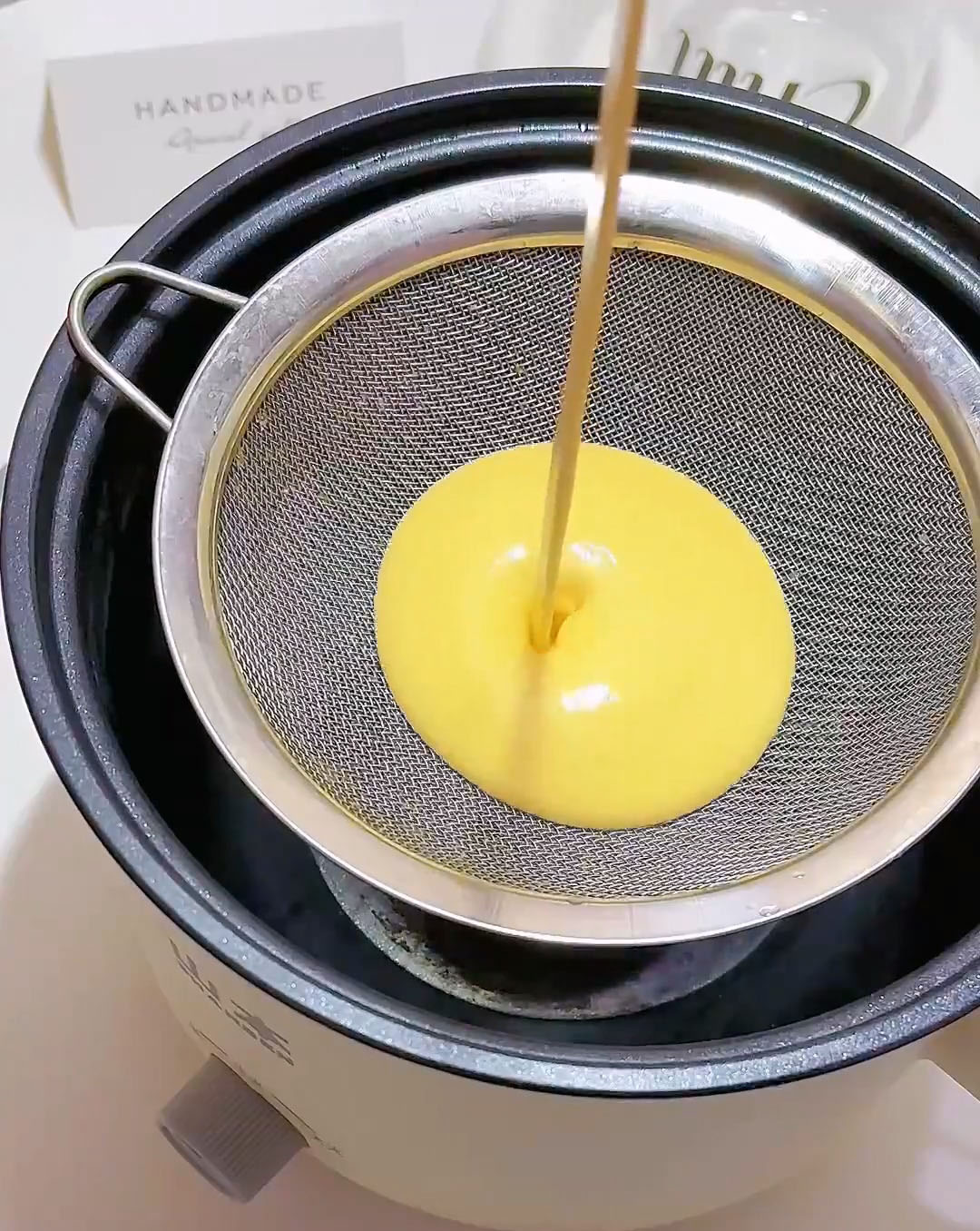strain the mixture through a fine mesh sieve directly into a non stick pan